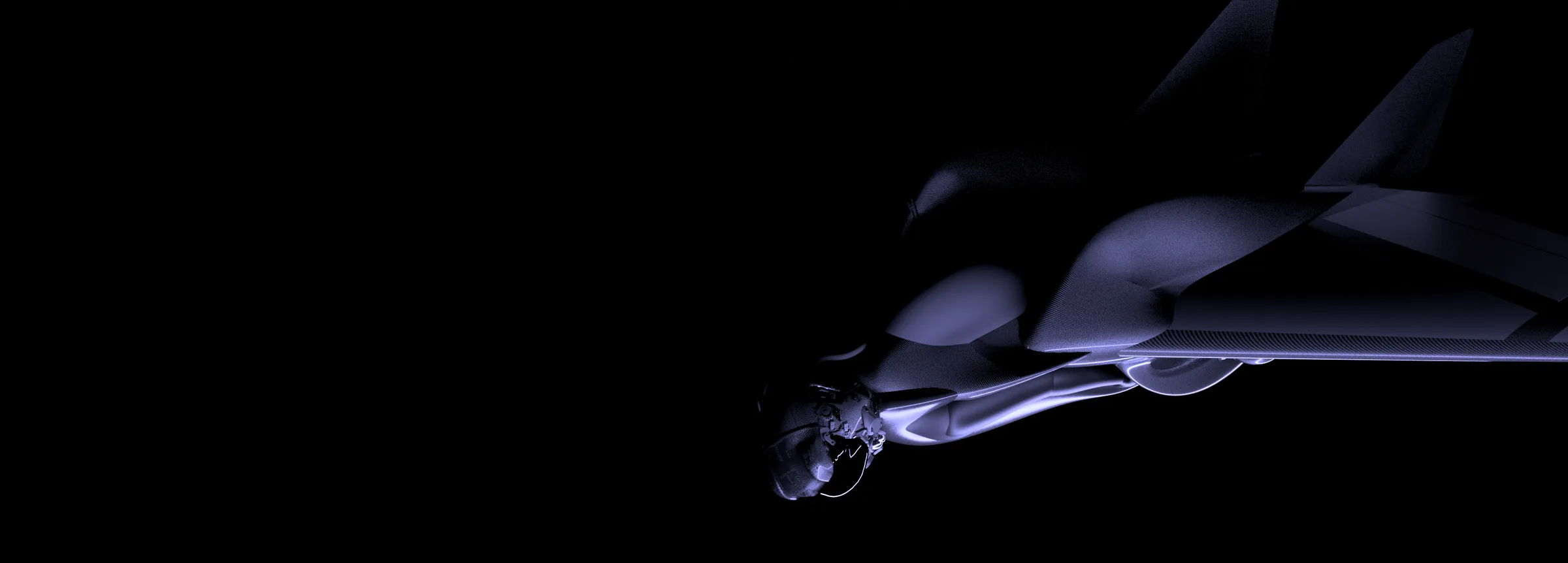 The Jetwing at night, lit in cold blue: the rider's helmet and the carbon shell with swept wings